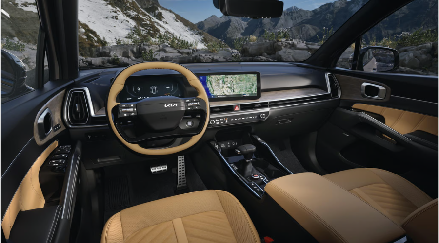 Interior view of a 2026 Kia Sorento curved touchscreen infotainment panel in Classic Kia showroom