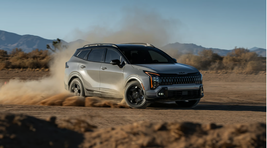 A rugged gray 2026 Kia Sportage utilizing its Active AWD traction system to corner dynamically on a dirt path, showcasing compact SUV performance capability for Gurnee and Waukegan IL drivers.
