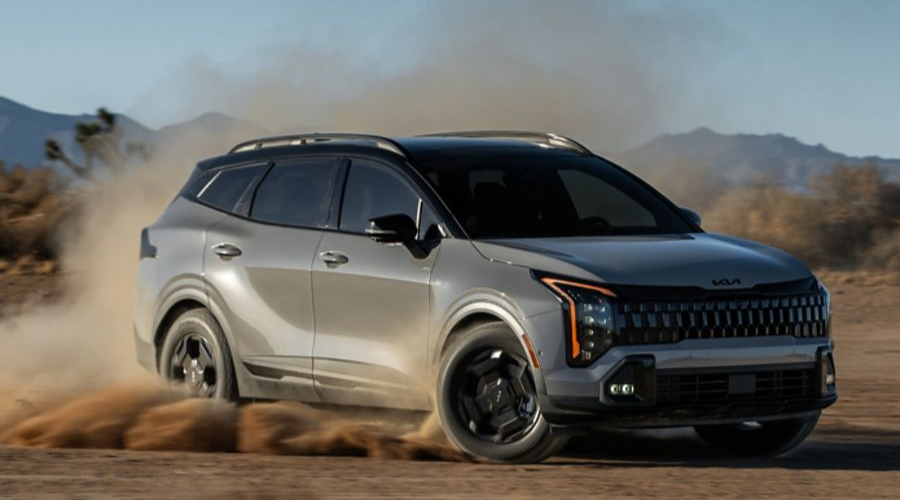 A gray 2026 Kia Sportage utilizing its Active AWD traction system to corner dynamically on a dirt path, showcasing compact SUV performance capability for Waukegan and Gurnee IL drivers