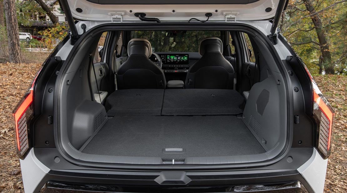 Cargo area and rear storage compartment of the 2027 Kia EV3 crossover at Classic Kia